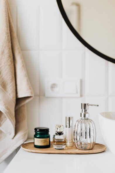 set of skincare supplies on white table in bathroom